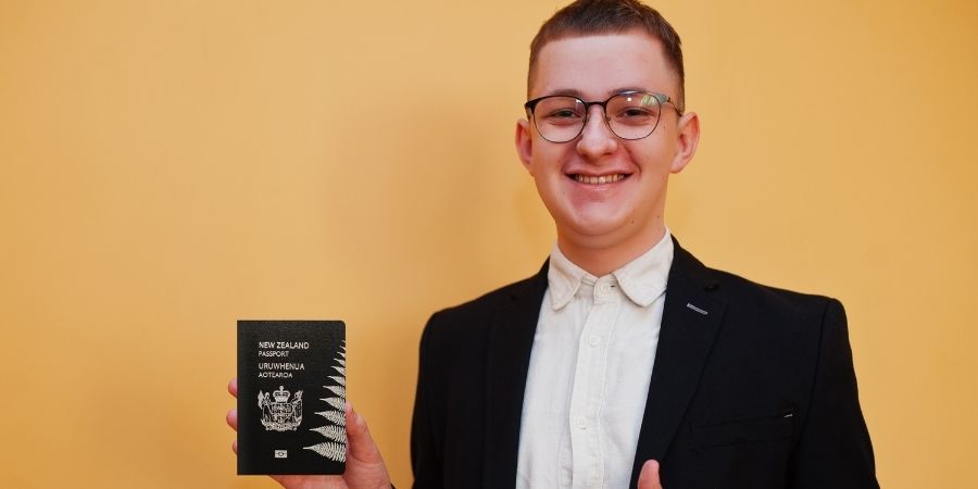 estudiante varon con pasaporte y visa en la mano en NZ